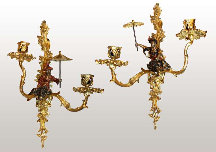 A pair of Louis XV lacquered
and giltbronze twin-branch wall-lights